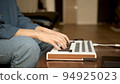 Woman hands playing on small keyboard, producer of music. Closeup of hands playing on keys, home 94925023