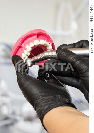 Dental instruments for teeth dental care in dentist's hands. 94925445