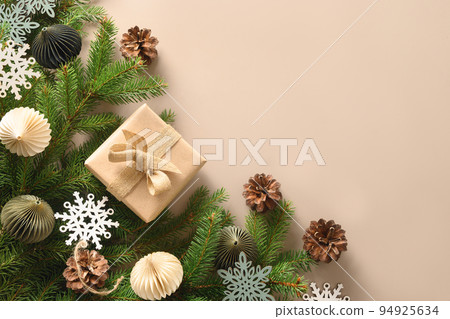 Christmas craft eco gift and festive composition with pine cones on beige background. 94925634