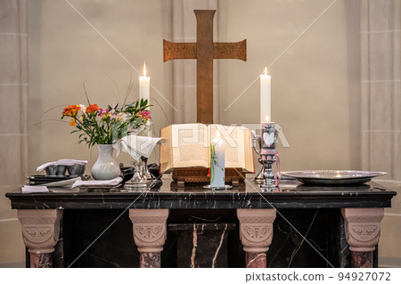 Festive interior decoration with burning candles in temple Church Christianity The ceremony of infant baptism Baptismal Festive interior decoration with burning candles in temple Church Christianity The ceremony of infant baptism Baptismal 94927072