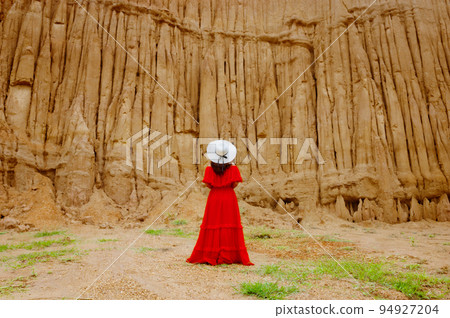 Women and landscape of soil textures eroded sandstone pillars, columns and cliffs, natural erosion of water and wind, Sao Din Na Noi, Hom Chom, Khok Suea at sri nan national park in Nan Province. Women and landscape of soil textures eroded sandstone pillars, columns and cliffs, natural erosion of water and wind, Sao Din Na Noi, Hom Chom, Khok Suea at sri nan national park in Nan Province. 94927204