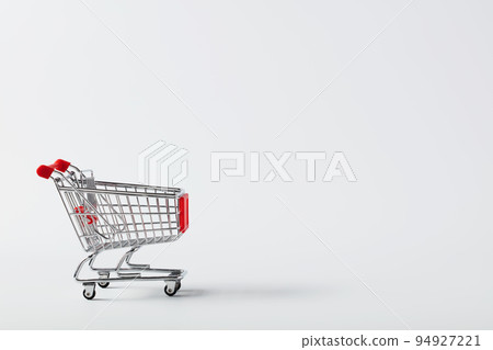 Shopping cart trolley on white background with copy space Shopping cart trolley on white background with copy space 94927221
