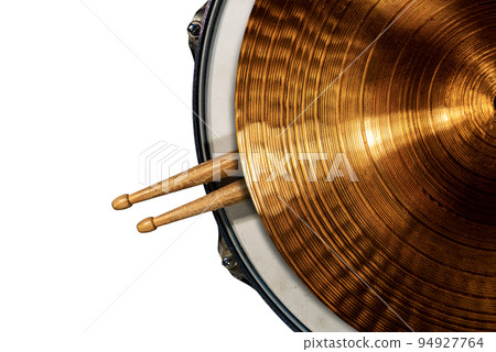 Golden Cymbal on a Snare Drum with two Wooden Drumsticks Isolated on White Golden Cymbal on a Snare Drum with two Wooden Drumsticks Isolated on White 94927764