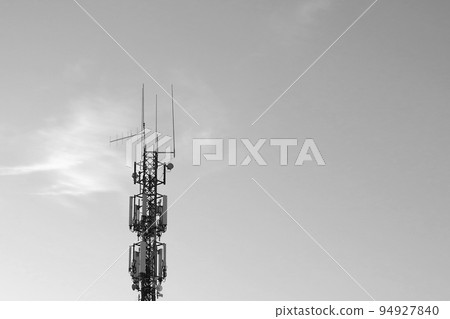 Black and white photo. Cell tower against the sky. Modern technologies. 94927840