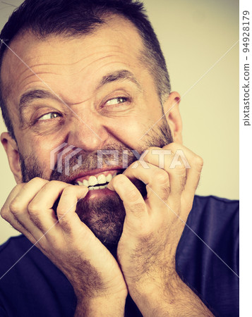 Man biting his nails Man biting his nails 94928179