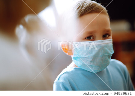 Little boy wearing a protective sterile medical mask. Child, wearing face mask. Covid-19. Little boy wearing a protective sterile medical mask. Child, wearing face mask. Covid-19. 94929681