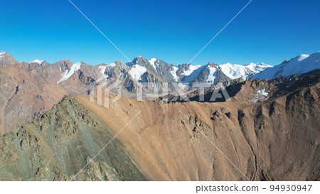 Rocky pass with a view of the snowy mountains 94930947