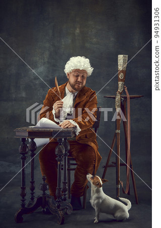 Invitation to hunting. Vintage portrait of young man in brown vintage suit and white wig like medieval royal hunter isolated on dark background. Invitation to hunting. Vintage portrait of young man in brown vintage suit and white wig like medieval royal hunter isolated on dark background. 94931306
