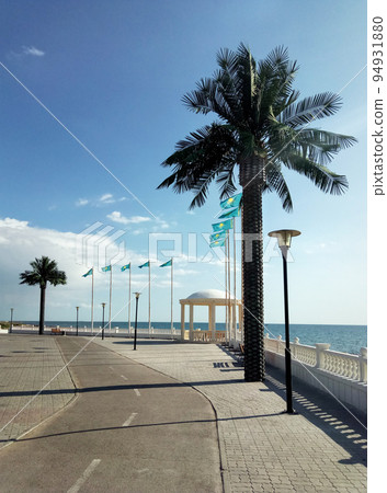 Artificial palm trees on the promenade. 94931880