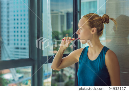 Young woman brushing his teeth in my bedroom 94932117