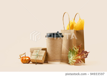 Fall Gift or Sale concept. Shopping paper bag, paper drink cup with gift boxes and pumpkin. Copy space. Thanksgiving. Packaging. Box order delivery. Mockup Fall Gift or Sale concept. Shopping paper bag, paper drink cup with gift boxes and pumpkin. Copy space. Thanksgiving. Packaging. Box order delivery. Mockup 94933597