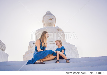 Mother and son tourists on the Big Buddha statue. Was built on a high hilltop of Phuket Thailand Can be seen from a distance 94934018