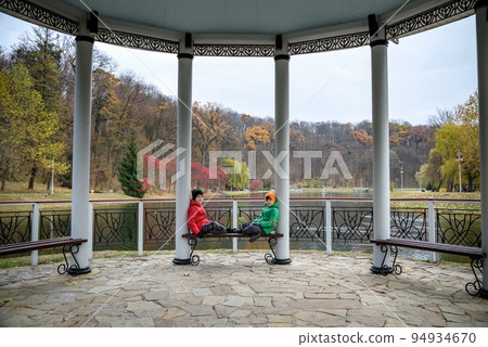 Two siblings stand on the bridge and admire the magnificent view Two siblings stand on the bridge and admire the magnificent view 94934670