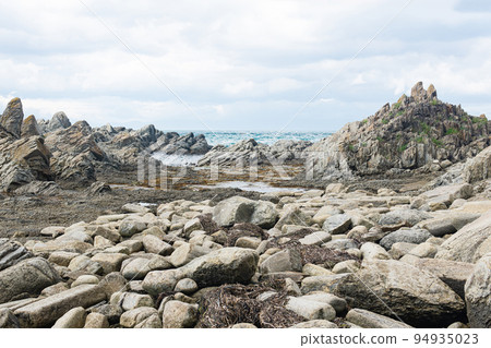 ocean shore with rocks of columnar basalt, Cape Stolbchaty on Kunashir Island ocean shore with rocks of columnar basalt, Cape Stolbchaty on Kunashir Island 94935023