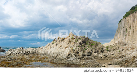 ocean shore with rocks of columnar basalt, Cape Stolbchaty on Kunashir Island ocean shore with rocks of columnar basalt, Cape Stolbchaty on Kunashir Island 94935024