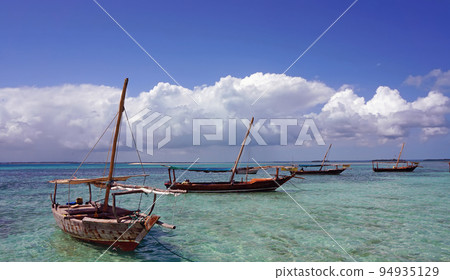 Traditional fishing boat standing on the shore in the clear water of the Indian Ocean. island of Madagascar 94935129