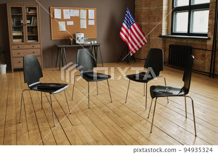Several chairs making circle prepared for attendants of PTSD support group 94935324