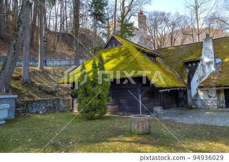 Bran, Romania house, green moss on roof and Castle 94936029