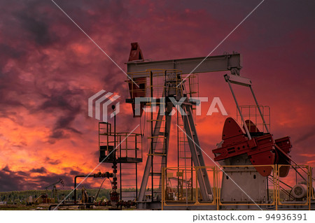 Oil drill rig and pump jack at sunset background. 94936391