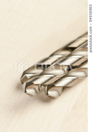 Close-up of a set of drills for wood and metal. For drilling hard metals and wood. Drilling tool for wood and furniture making Close-up of a set of drills for wood and metal. For drilling hard metals and wood. Drilling tool for wood and furniture making 94936963