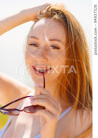 portrait of a beautiful and sexy young woman with long hair with sunglasses  94937326