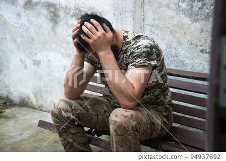 Sad soldier sits on the bench Sad soldier sits on the bench 94937692