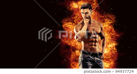 Bodybuilder posing on the fire flames background 94937724