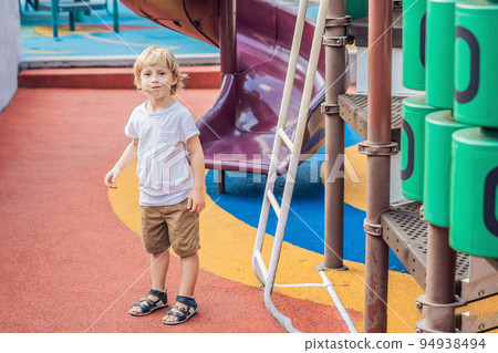 Funny cute happy baby playing on the playground. The emotion of happiness, fun, joy 94938494