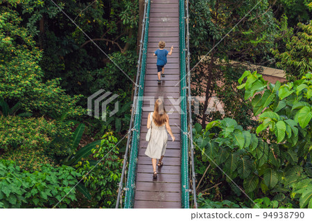Mother and son at the Suspension bridge in Kuala Lumpur, Malaysia 94938790