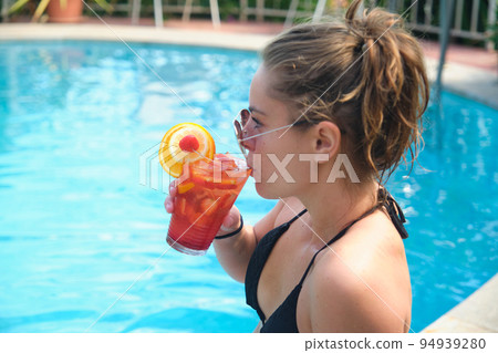 a pretty young girl at the pool a pretty young girl at the pool 94939280
