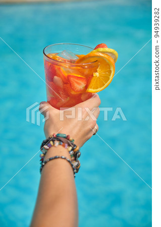 women's hands with a glass of cocktail women's hands with a glass of cocktail 94939282