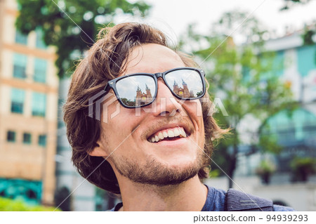 A man looks at Notre dame de Saigon Cathedral, build in 1883 in Ho Chi Minh city, Vietnam. Reflection in glasses 94939293
