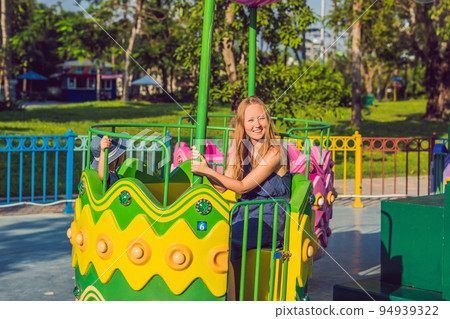 Mom and son having fun at an amusement park 94939322