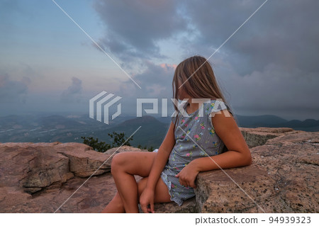 portrait of a girl against the sky and mountains portrait of a girl against the sky and mountains 94939323