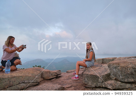 mother photographs her daughter in the mountains mother photographs her daughter in the mountains 94939325