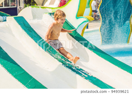 Boy is having fun in the water park Boy is having fun in the water park 94939621