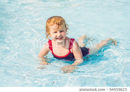 Little Girl having fun in the water park Little Girl having fun in the water park 94939623