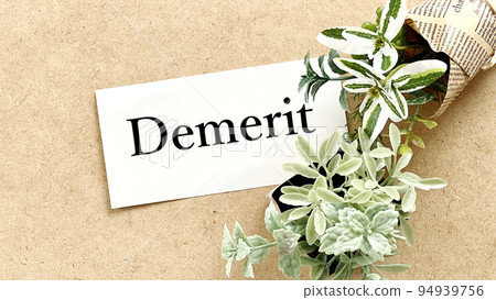 Demerit letters and plants on white paper on corkboard_wide Demerit letters and plants on white paper on corkboard_wide 94939756
