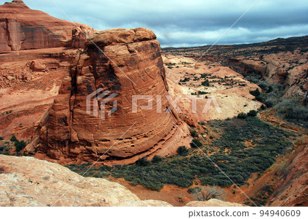 United States Colorado Plateau in early spring Arches National Park Delicate Arch upper observation deck overlooking the valley United States Colorado Plateau in early spring Arches National Park Delicate Arch upper observation deck overlooking the valley 94940609