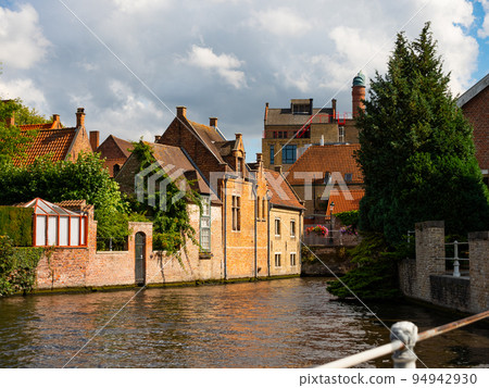 Stone buildings along canal in Bruges, Belgium Stone buildings along canal in Bruges, Belgium 94942930