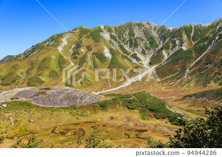 Tateyama Kurobe Alpine Route in full bloom in autumn colors Tateyama mountain range from Murododaira 94944286