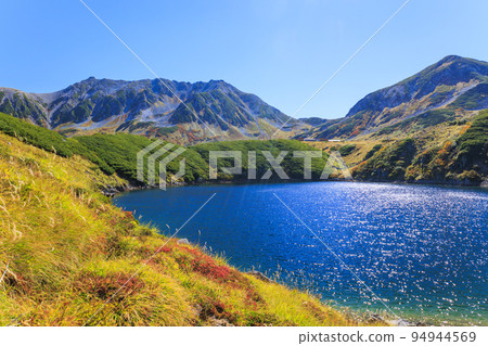 Tateyama Kurobe Alpine Route in full bloom in autumn colors Tateyama mountain range from Murododaira 94944569