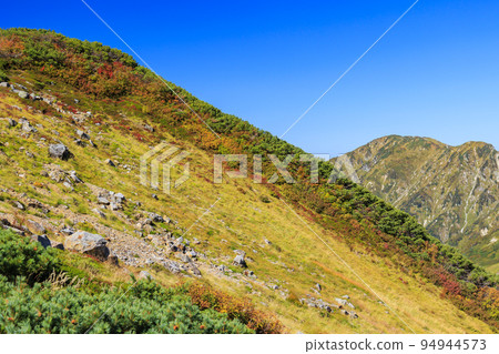 Tateyama Kurobe Alpine Route in full bloom in autumn colors Tateyama mountain range from Murododaira 94944573
