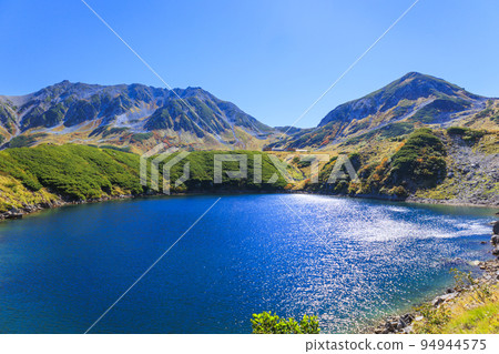 Tateyama Kurobe Alpine Route in full bloom in autumn colors Tateyama mountain range from Murododaira 94944575
