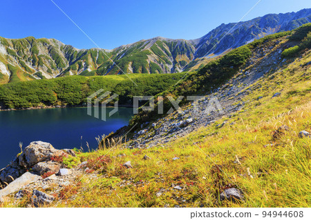 Tateyama Kurobe Alpine Route in full bloom in autumn colors Tateyama mountain range from Murododaira 94944608