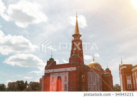Muslim mosque. Beautiful mosque against the blue sky and clouds. 94945231
