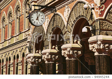 Street clock and old Gothic building in the afternoon 94945244