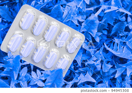 Light bister with white pills on blue foliage Light bister with white pills on blue foliage 94945308