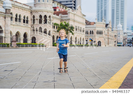 Boy on background of Sultan Abdul Samad Building in Kuala Lumpur, Malaysia. Traveling with children concept Boy on background of Sultan Abdul Samad Building in Kuala Lumpur, Malaysia. Traveling with children concept 94946337