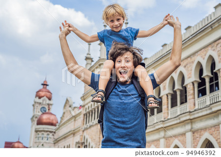 Dad and son on background of Sultan Abdul Samad Building in Kuala Lumpur, Malaysia. Traveling with children concept 94946392